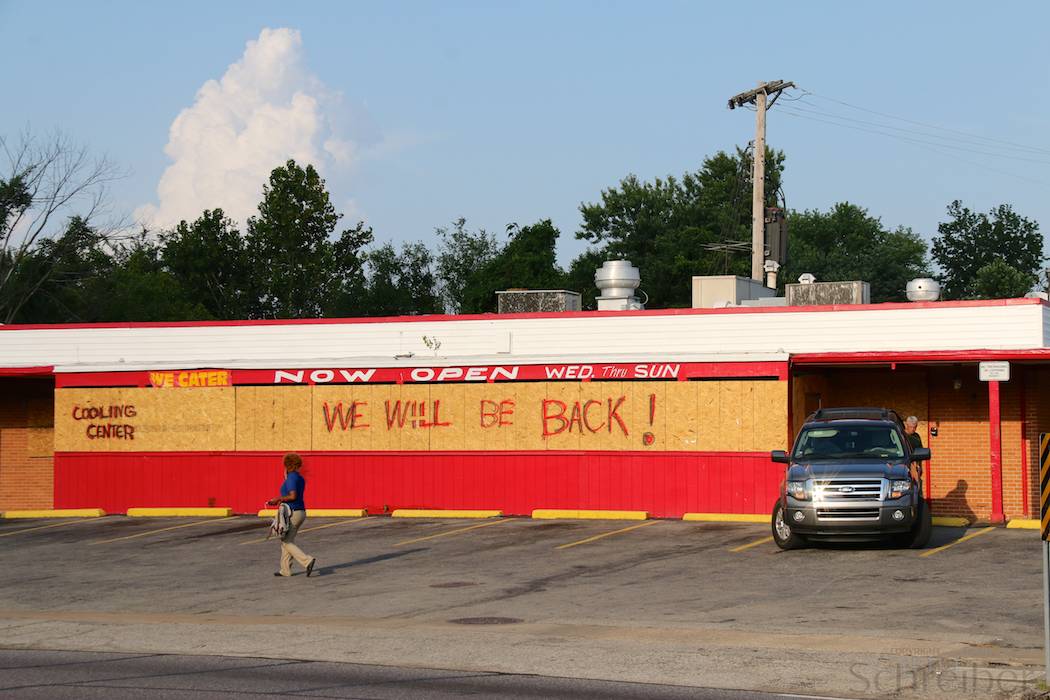 The sentence "we will be back" is written on wood protecting the windows of a shop in Ferguson, a suburb of St Louis, MO, Monday, August 25, 2014. Violent uprisings following the shooting of teenager Michael Brown by police officer Darren Wilson have left the city partly destroyed. (Yann Schreiber)