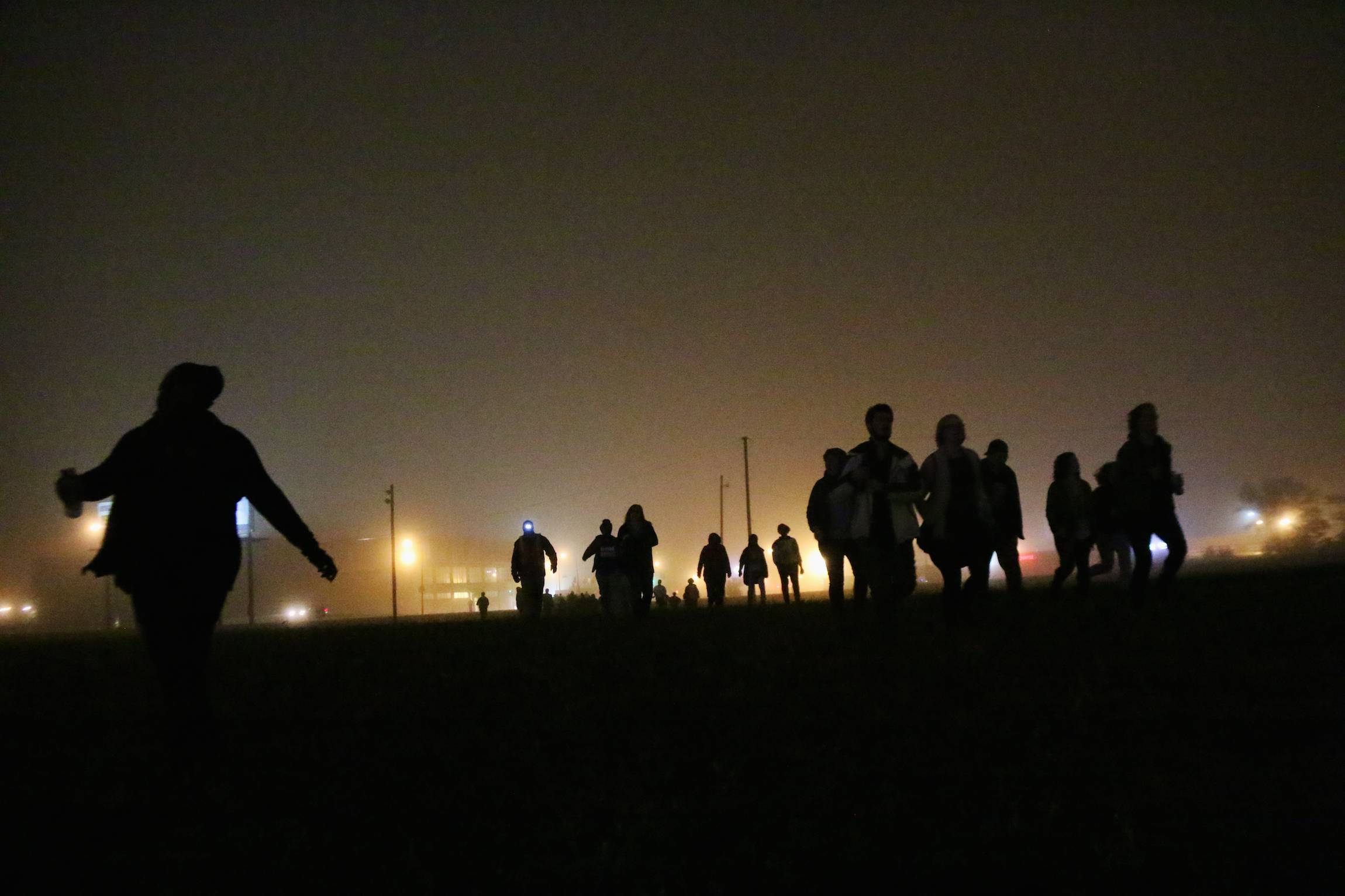 Protesters run across a field in St. Louis, in the early hours of Monday, Oct. 13, 2014. The Sunday-night protest demanded justice for a series of police killings, including Michael Brown, shot by officer Darren Wilson in Ferguson, Aug. 9, 2014.