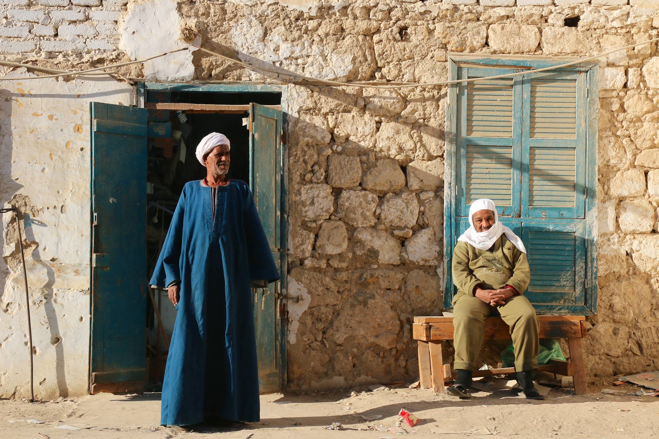 Men stand and sit in front of a house in El Quseir, Egypt, Jan. 8, 2014.