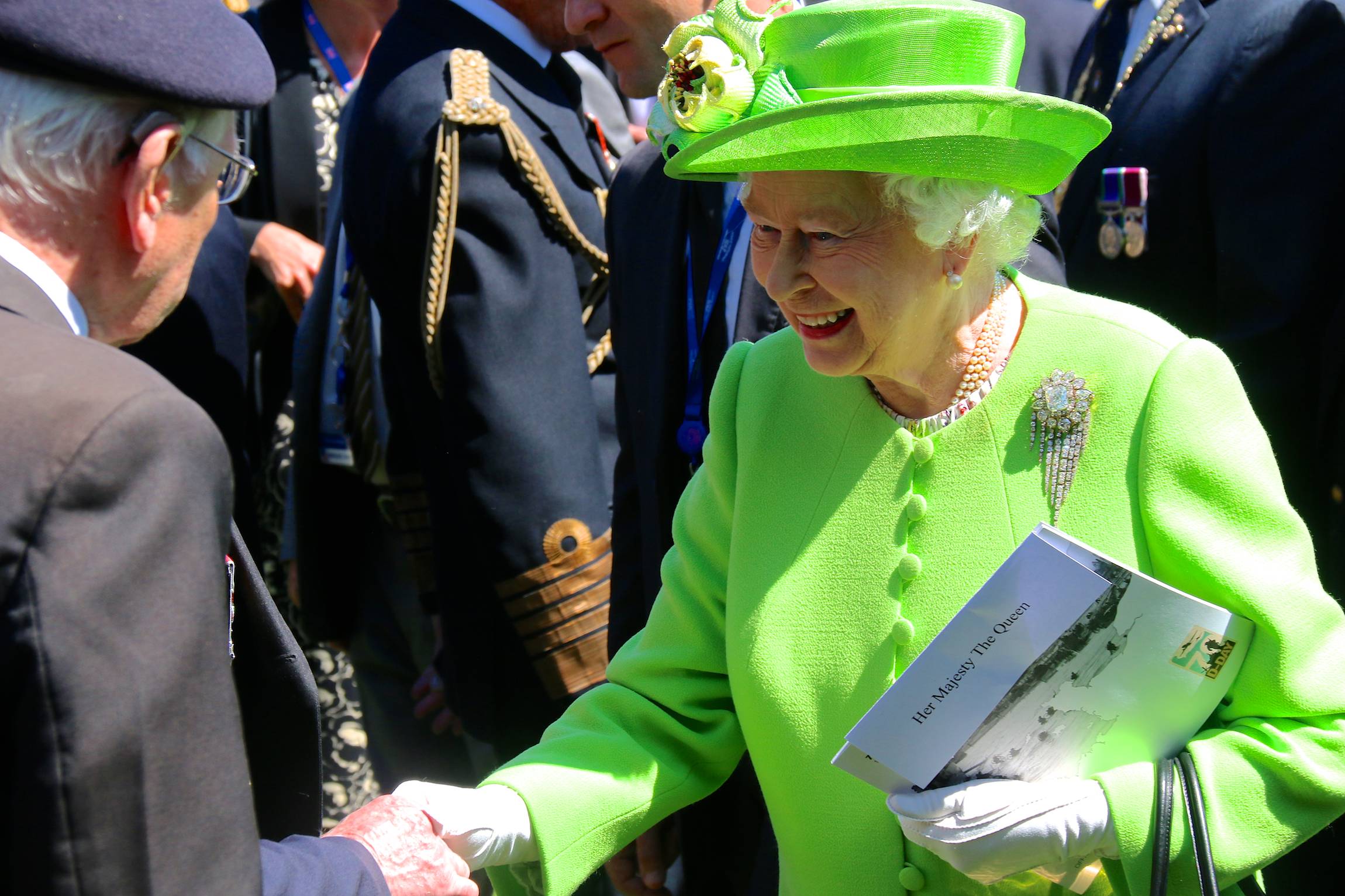 Queen Elisabeth II greets a veteran after the Franco-British Ceremony of the 70th anniversary of D-Day, on the Bayeux Cemetery in France, June 6, 2014.